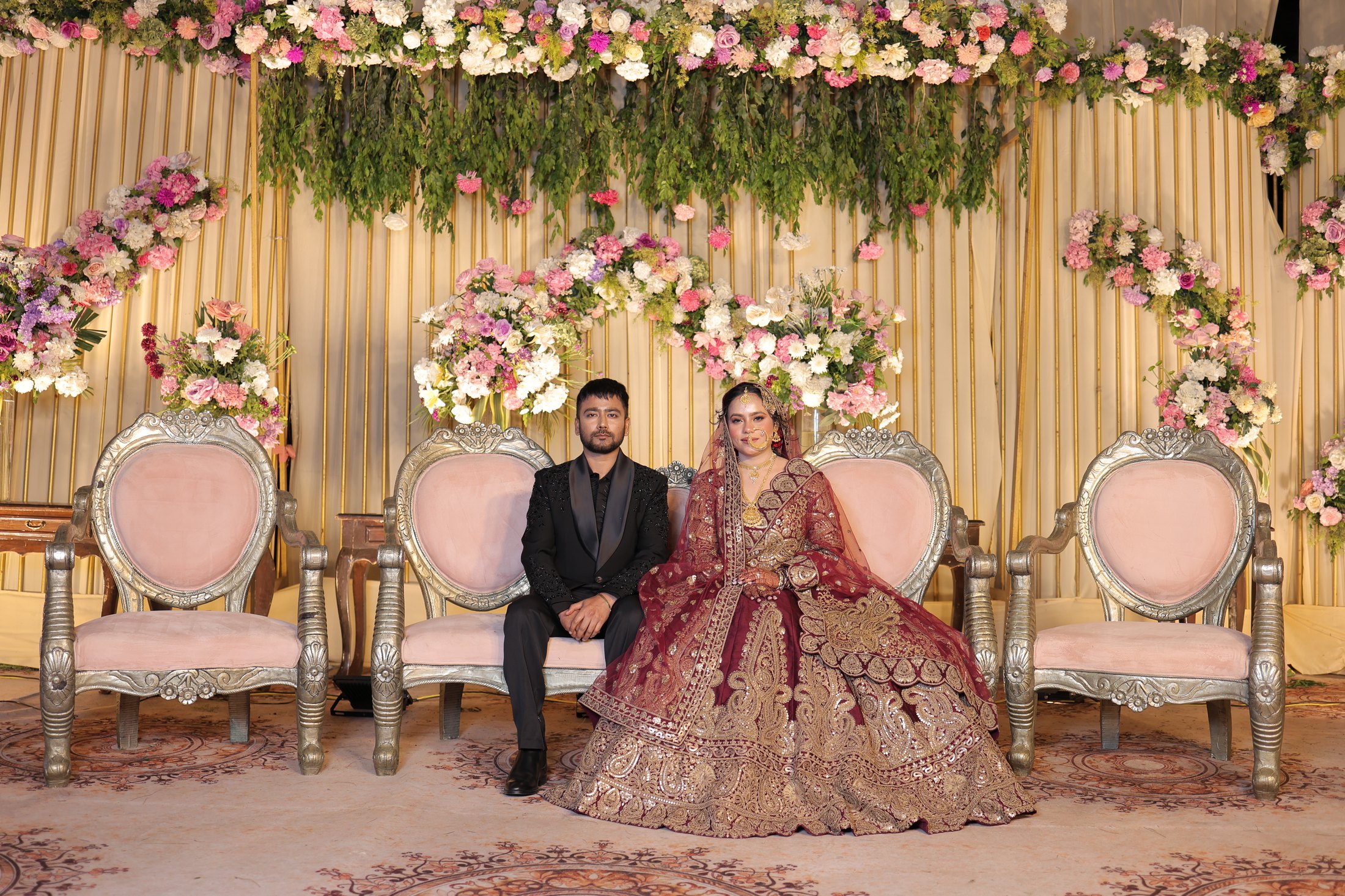 Elegant celebration tent with floral arrangements and chandelier lighting